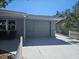 Exterior with a one-car garage, covered entrance, and inviting seating on the porch at 3136 Primrose Dr, Holiday, FL 34691