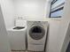 Laundry room featuring a washing machine, dryer, and a window at 3136 Primrose Dr, Holiday, FL 34691
