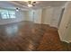 Spacious living room with modern flooring, ceiling fans, and ample natural light at 3136 Primrose Dr, Holiday, FL 34691
