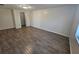 A spacious living room features wood-look flooring and neutral walls at 3136 Primrose Dr, Holiday, FL 34691