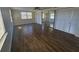 Bright main bedroom with wood-look floors, a ceiling fan, and mirrored closet doors at 3136 Primrose Dr, Holiday, FL 34691