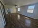 Large main bedroom featuring spacious closets, windows, and wood-look flooring at 3136 Primrose Dr, Holiday, FL 34691