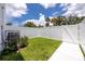 A spacious backyard with a privacy fence, green grass and mature trees at 3402 E 28Th Ave # 7, Tampa, FL 33605