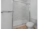 Modern bathroom with a new toilet and large glass enclosed shower with marble tile surround at 3402 E 28Th Ave # 7, Tampa, FL 33605