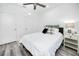 Comfortable bedroom featuring a ceiling fan, white walls, and ample closet space at 3402 E 28Th Ave # 7, Tampa, FL 33605