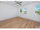 Bright bedroom featuring wood floors, ceiling fan, and double windows at 3402 E 28Th Ave # 7, Tampa, FL 33605