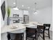 Sleek kitchen island with bar seating and modern pendant lighting at 3402 E 28Th Ave # 7, Tampa, FL 33605