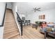 Bright living room with hardwood floors, ceiling fan, and modern furnishings adjacent to a contemporary kitchen at 3402 E 28Th Ave # 7, Tampa, FL 33605