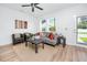 Well-lit living room with hardwood floors and modern furnishings, complemented by a view through the windows at 3402 E 28Th Ave # 7, Tampa, FL 33605