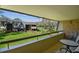 Spacious balcony offers views of the well-maintained grounds and nearby building at 36750 Us Highway 19 N # 01205, Palm Harbor, FL 34684