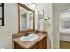 Well lit bathroom featuring a single vanity, toilet, shower with neutral colored walls and fixtures at 36750 Us Highway 19 N # 01205, Palm Harbor, FL 34684