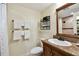 Cozy bathroom featuring a single vanity, toilet, shower with neutral colored walls and coordinated fixtures at 36750 Us Highway 19 N # 01205, Palm Harbor, FL 34684