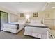 Bright and spacious bedroom with two beds, decor, and access to balcony at 36750 Us Highway 19 N # 01205, Palm Harbor, FL 34684