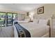 Bright bedroom with two queen beds, sliding glass doors to balcony, and neutral color scheme at 36750 Us Highway 19 N # 01205, Palm Harbor, FL 34684