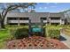 Inviting condo exterior with manicured landscaping, sign, and traditional architectural details at 36750 Us Highway 19 N # 01205, Palm Harbor, FL 34684