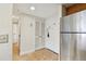 Hallway with neutral-toned floors, refrigerator, and closet storage at 36750 Us Highway 19 N # 01205, Palm Harbor, FL 34684