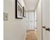 Hallway with neutral colors, framed artwork, and closet doors, creating a welcoming entrance at 36750 Us Highway 19 N # 01205, Palm Harbor, FL 34684