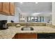 Granite countertop divides the kitchen from other living spaces and provides a functional breakfast bar at 36750 Us Highway 19 N # 01205, Palm Harbor, FL 34684