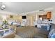 Spacious living area with beds, living room seating, a dining table, and a full kitchen at 36750 Us Highway 19 N # 01205, Palm Harbor, FL 34684
