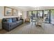 Comfortable living room offers a sofa, chairs, and a dining area with balcony access at 36750 Us Highway 19 N # 01205, Palm Harbor, FL 34684