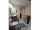 Bathroom boasting a commode, tile flooring, vanity and view to hall at 38339 Eucalyptus Dr, Zephyrhills, FL 33542