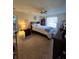 Bedroom boasting carpet flooring, a ceiling fan and a large window with sheer curtains at 38339 Eucalyptus Dr, Zephyrhills, FL 33542