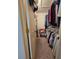 Walk-in closet filled with clothes, shoes and storage containers with a door to the left at 38339 Eucalyptus Dr, Zephyrhills, FL 33542