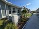 Attractive exterior showing the landscaping leading to the home, featuring well-kept lawns and flowering plants at 38339 Eucalyptus Dr, Zephyrhills, FL 33542