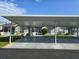 Exterior shot showcasing attached covered parking with beautiful landscaping and the facade of a single-story home at 38339 Eucalyptus Dr, Zephyrhills, FL 33542