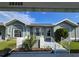 Charming exterior view with arched windows, tidy landscaping, and a welcoming entrance under a bright blue sky at 38339 Eucalyptus Dr, Zephyrhills, FL 33542