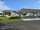 Wide exterior view displays a charming home with a carport, landscaped lawn, and an inviting entrance at 38339 Eucalyptus Dr, Zephyrhills, FL 33542