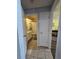 Hallway leading to bathroom, featuring neutral colors and clean design, offering a seamless transition between spaces at 38339 Eucalyptus Dr, Zephyrhills, FL 33542