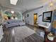 Cozy living room featuring gray sofa, plush rug, and modern decor at 38339 Eucalyptus Dr, Zephyrhills, FL 33542
