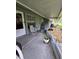 Cozy covered patio features comfortable seating and a well-kept garden bed, providing a peaceful retreat at 38339 Eucalyptus Dr, Zephyrhills, FL 33542