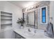 Bathroom with white countertop, decorative mirror, and a potted plant at 3834 Kim Dr, Wesley Chapel, FL 33543