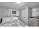 Cozy bedroom with a patterned comforter, closet and small dresser at 3834 Kim Dr, Wesley Chapel, FL 33543