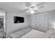 Bedroom with a ceiling fan, large closet, and a flat screen television at 3834 Kim Dr, Wesley Chapel, FL 33543
