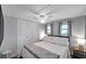 Bedroom with fan, large closet and bed with decorative pillows and blanket at 3834 Kim Dr, Wesley Chapel, FL 33543