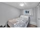 Cozy bedroom with a patterned comforter and a window letting in natural light at 3834 Kim Dr, Wesley Chapel, FL 33543