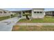 Charming home features a covered parking area and beautiful yard with well-maintained landscaping at 3834 Kim Dr, Wesley Chapel, FL 33543