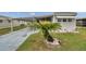 Charming home features a covered parking area and beautiful yard with well-maintained landscaping at 3834 Kim Dr, Wesley Chapel, FL 33543