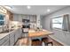 Modern kitchen with stainless steel appliances, light gray cabinetry, and wood block island at 3834 Kim Dr, Wesley Chapel, FL 33543