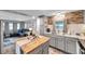 Open-concept kitchen with stainless steel appliances, light gray cabinetry, and adjacent living room at 3834 Kim Dr, Wesley Chapel, FL 33543