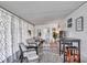 Inviting sunroom with stylish seating, patterned curtains, and a cozy rug for a relaxing atmosphere at 3834 Kim Dr, Wesley Chapel, FL 33543