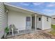 Exterior view of the property features a porch, exterior door and rock landscaping at 3834 Kim Dr, Wesley Chapel, FL 33543