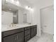 Contemporary bathroom featuring dual sinks, dark cabinets, and marble flooring at 408 W Paris St, Tampa, FL 33604