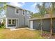 Exterior of a gray two-story home with a detached garage, landscaping, and a well-maintained yard at 408 W Paris St, Tampa, FL 33604