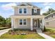 Charming two-story home featuring a welcoming front porch and professionally landscaped yard at 408 W Paris St, Tampa, FL 33604