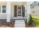 Close-up of the front entrance featuring a red door, white columns, and brick accents at 408 W Paris St, Tampa, FL 33604