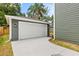 Spacious detached garage with a pristine white door and exterior lighting, enhancing curb appeal at 408 W Paris St, Tampa, FL 33604